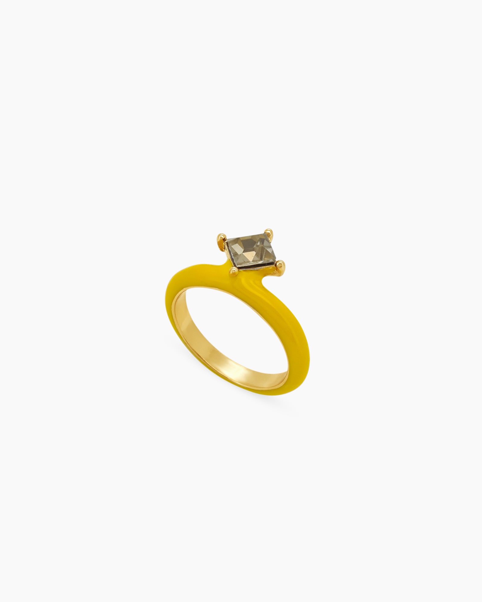 A yellow ring with a glossy enamel band and a striking triangular-cut olive-green gemstone