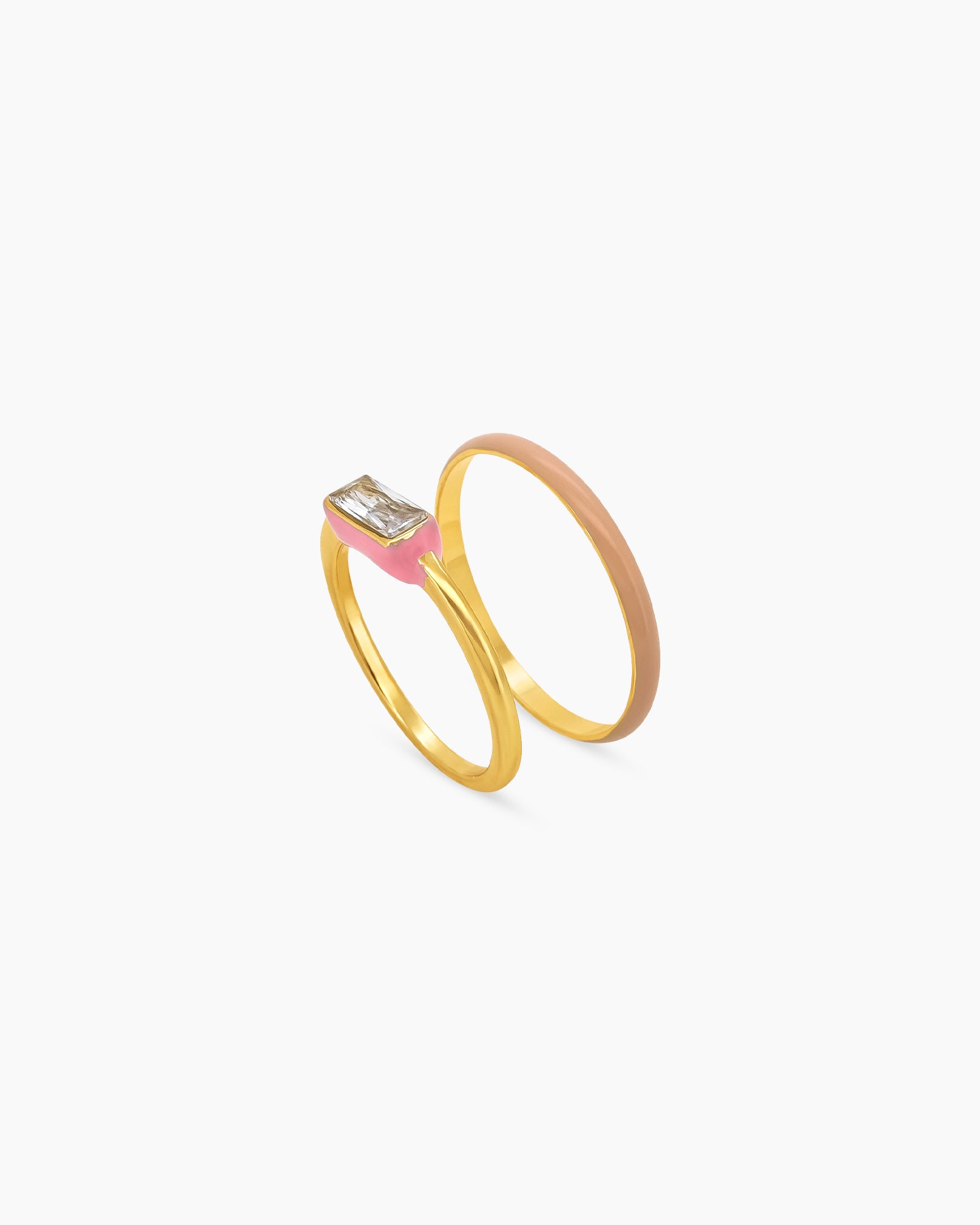 A set of pink stackable rings featuring a mix of sleek enamel finishes, polished bands, and subtle sparkle