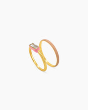 A set of pink stackable rings featuring a mix of sleek enamel finishes, polished bands, and subtle sparkle