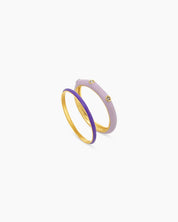 A set of purple stackable rings featuring a mix of sleek enamel finishes, polished bands, and subtle sparkle