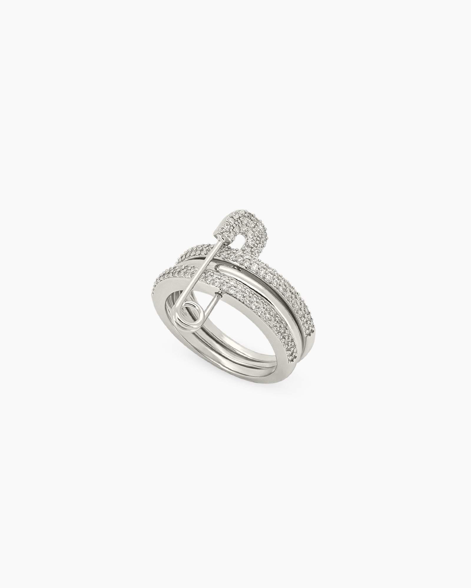 A silver stacked band ring with a crystal-studded safety pin detail for a stylish, daring twist