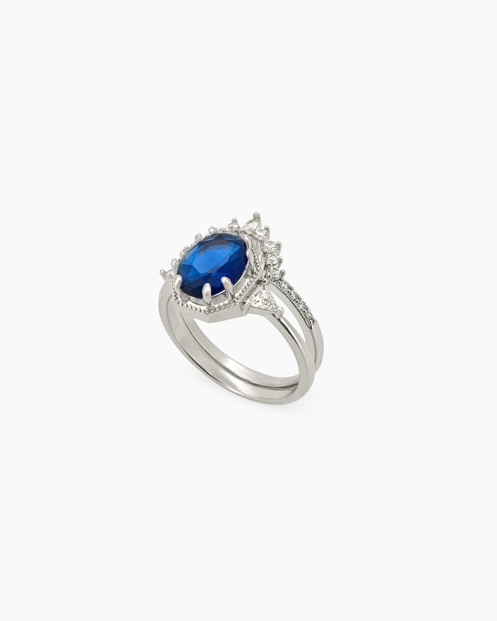 An enchanting duo of stacked rings in silver with a bold navy zircon set in a crown-like frame