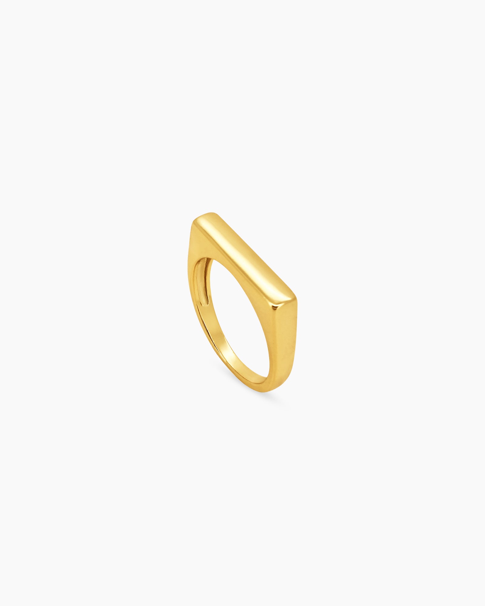 A ring with a beveled rectangular face and smooth gold finish for a retro spirit with modern finesse