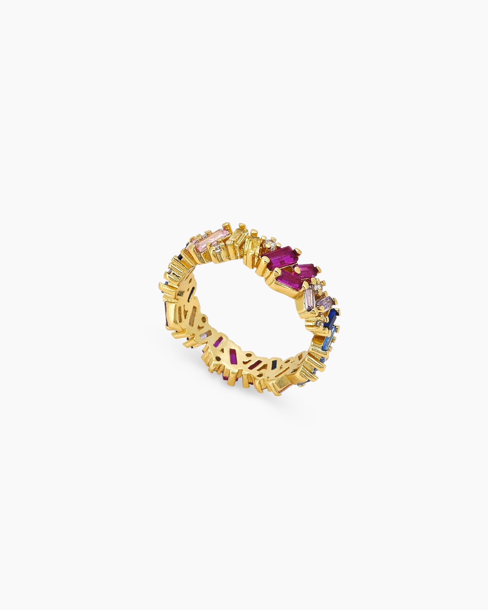 A band ring with baguette-cut zircons in dreamy shades, set at a playful, tilted angle on a gold band