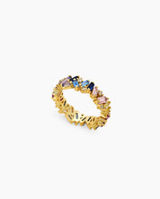 A band ring with baguette-cut zircons in dreamy shades, set at a playful, tilted angle on a gold band