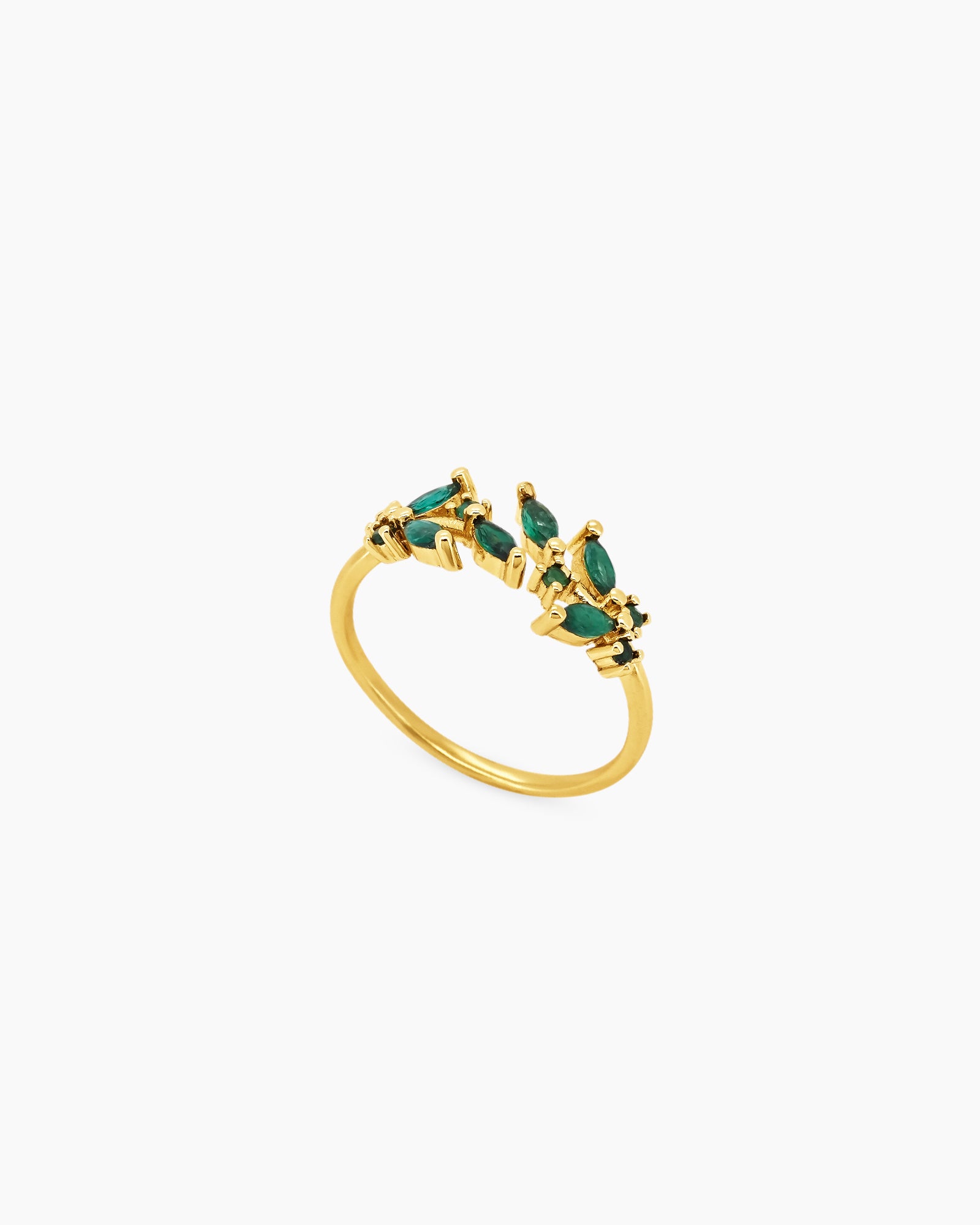 A green open ring with clusters of marquise-cut zircons that bloom from each side of the band