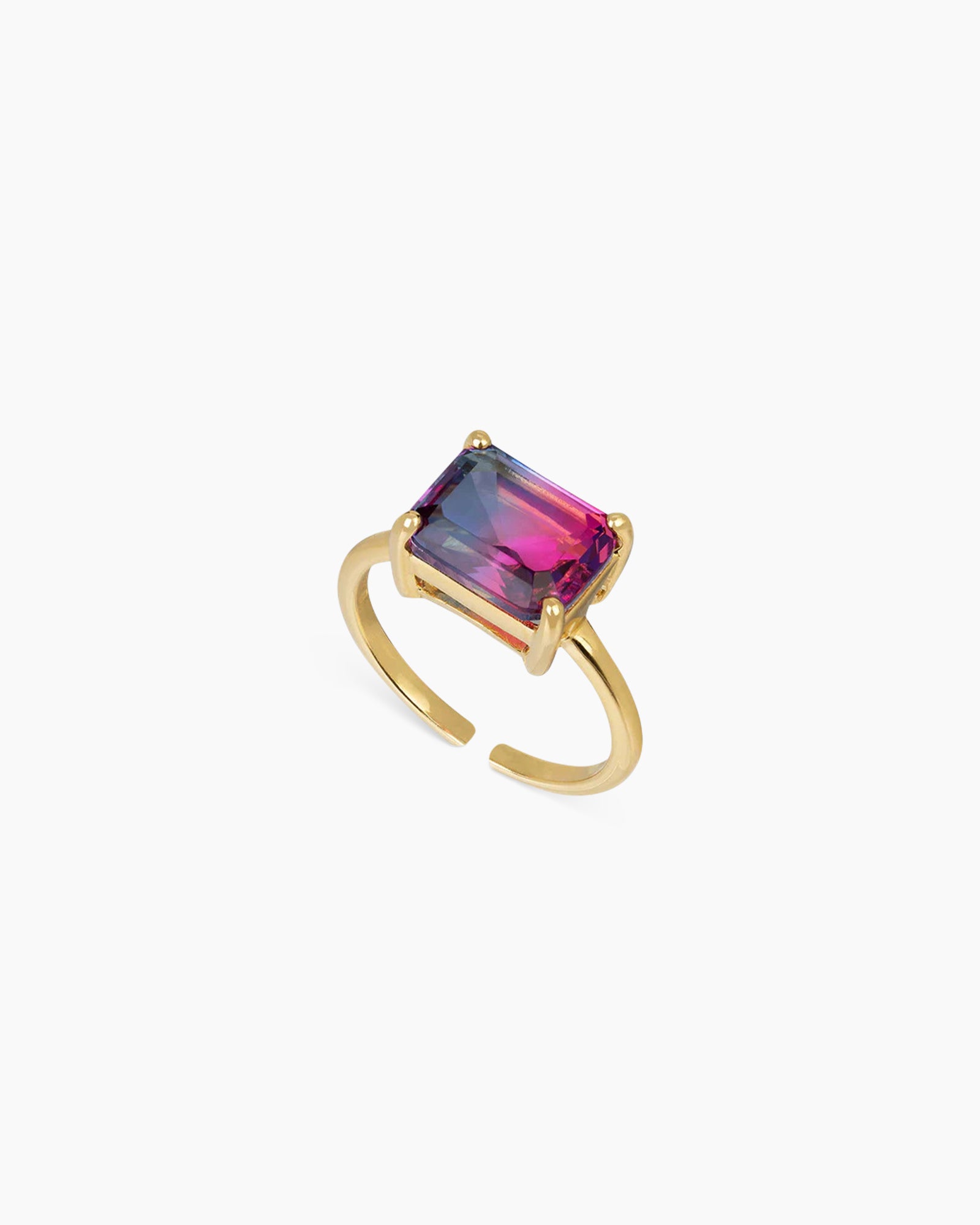 A blue-to-rose-red ring with an emerald-cut ombré zircon that shifts in the light, on a sleek open band