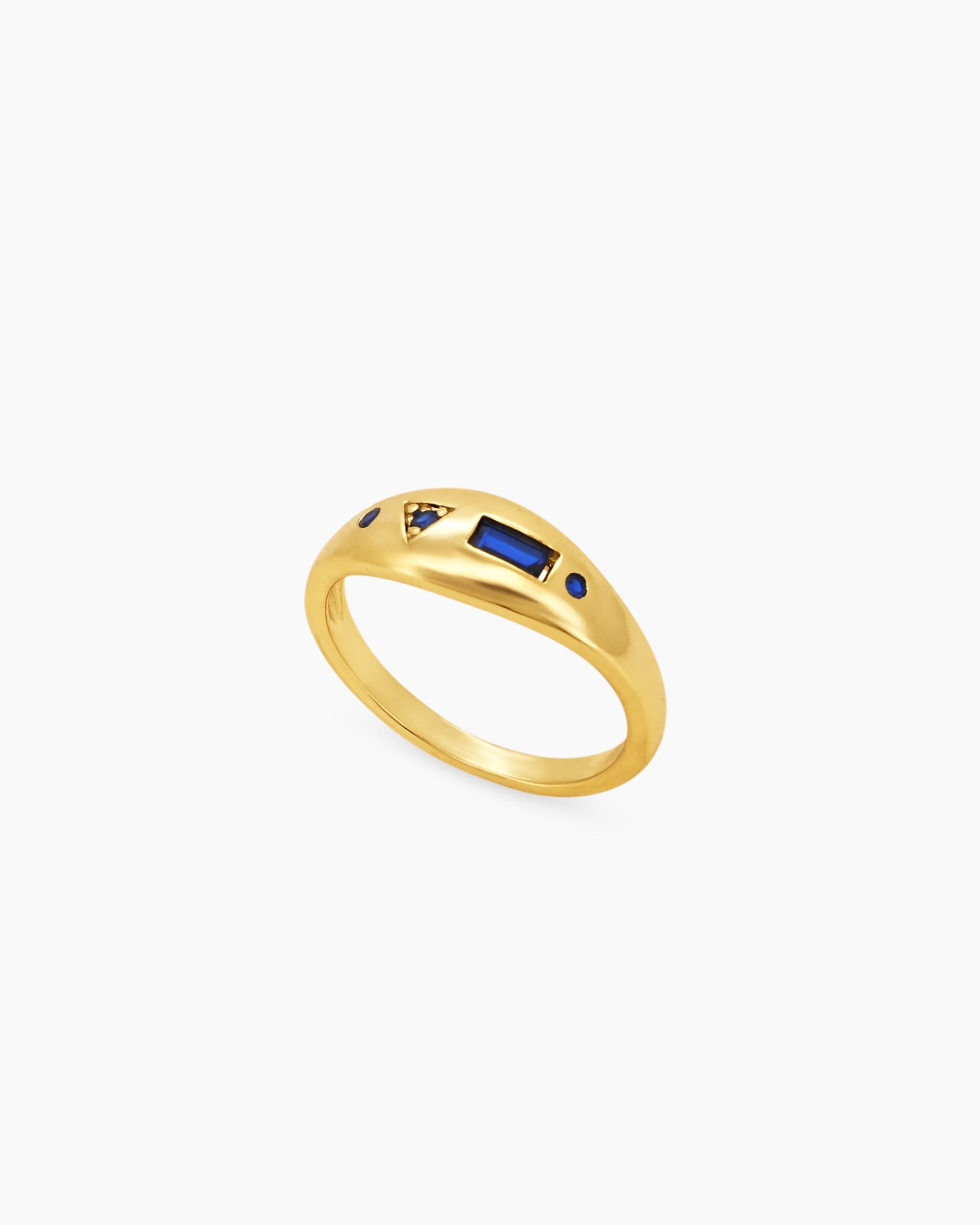 A ring with a bold navy baguette-cut zircon at its center, surrounded by tiny celestial accents