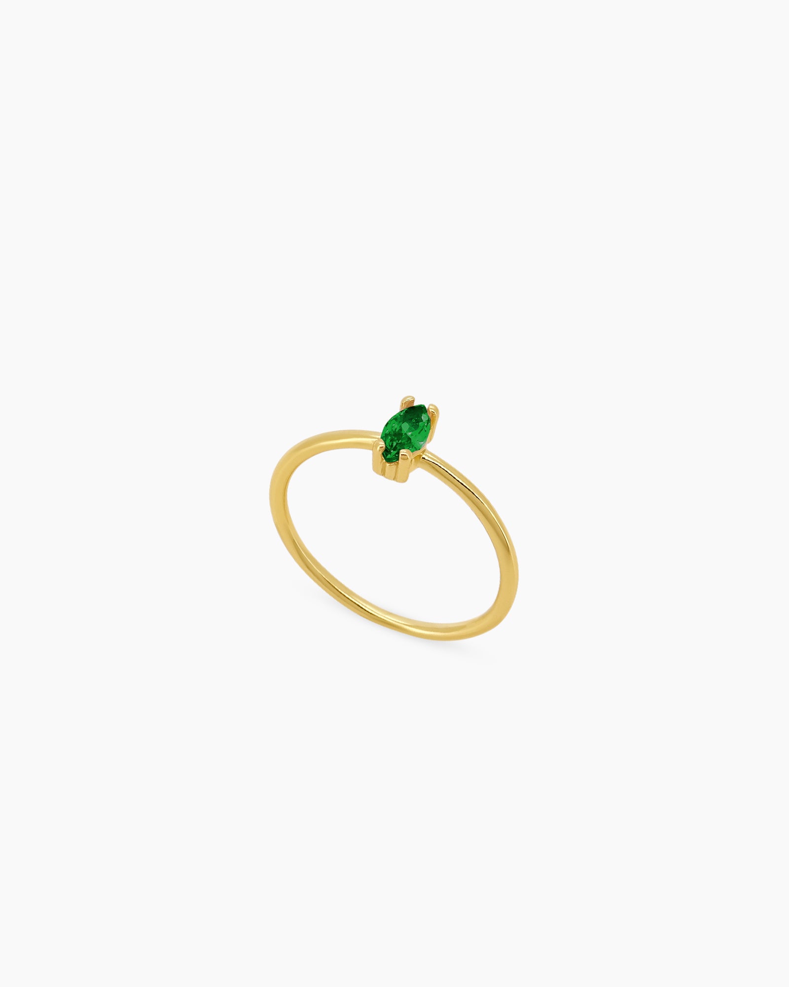 A green ring with a fine gold-plated band crowned with a marquise-cut zircon for a soft glimmer