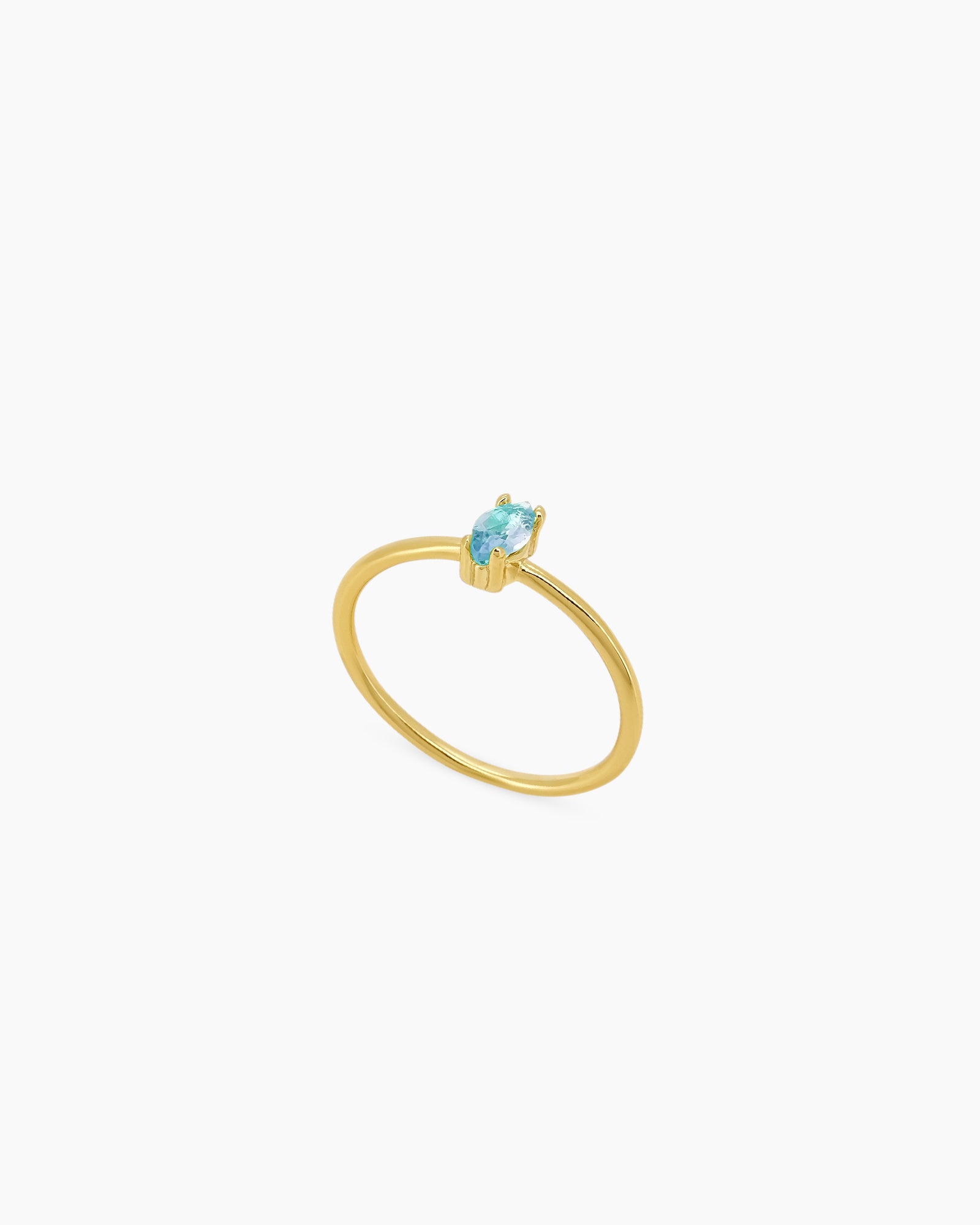 A light-blue ring with a fine gold-plated band crowned with a marquise-cut zircon for a soft glimmer