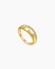 A gold-tone dome ring with a smooth finish, scattered with dainty star-shaped settings holding zircons