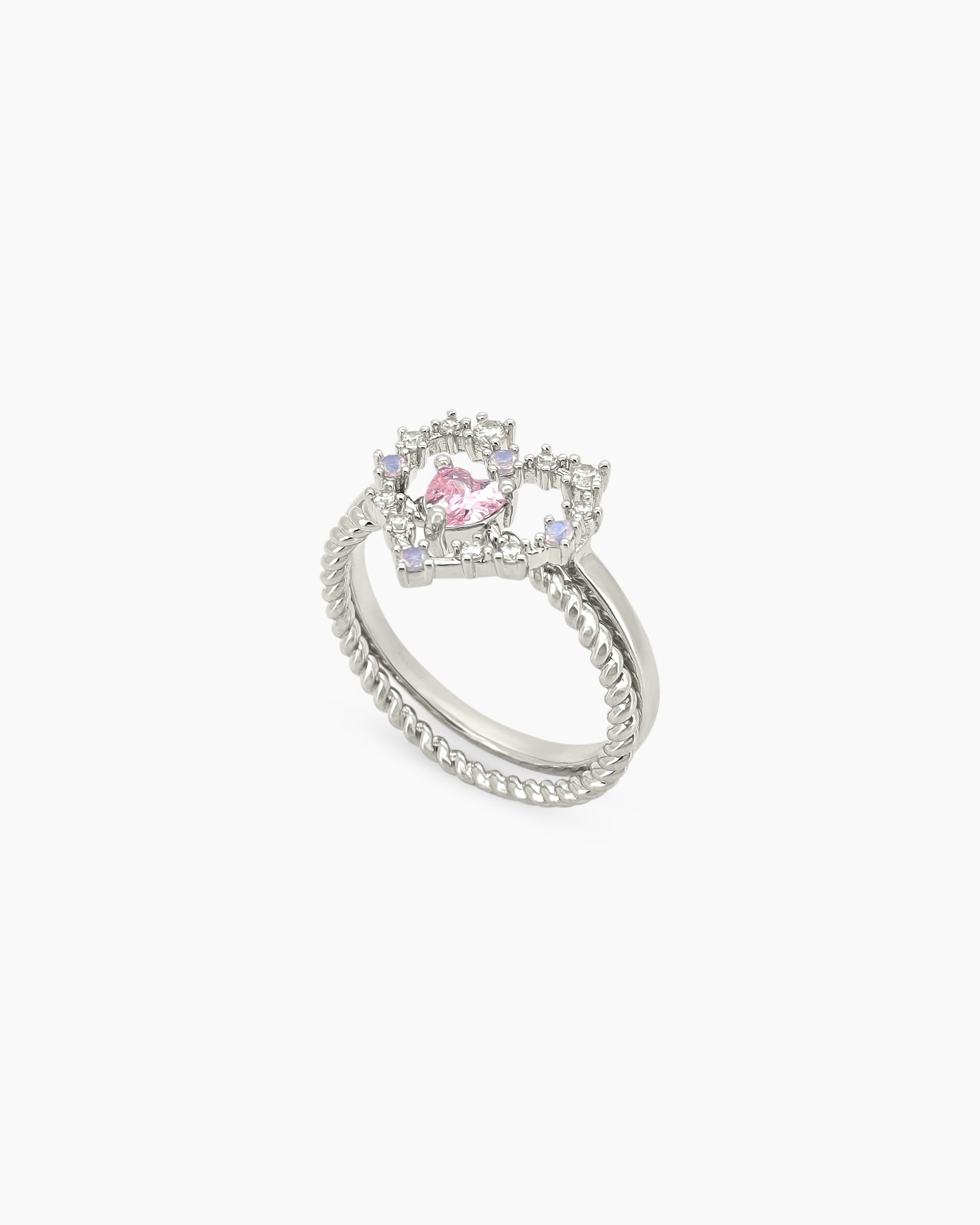 A ring set with a delicate open-heart silhouette and a sparkling pink heart stone for a magical look