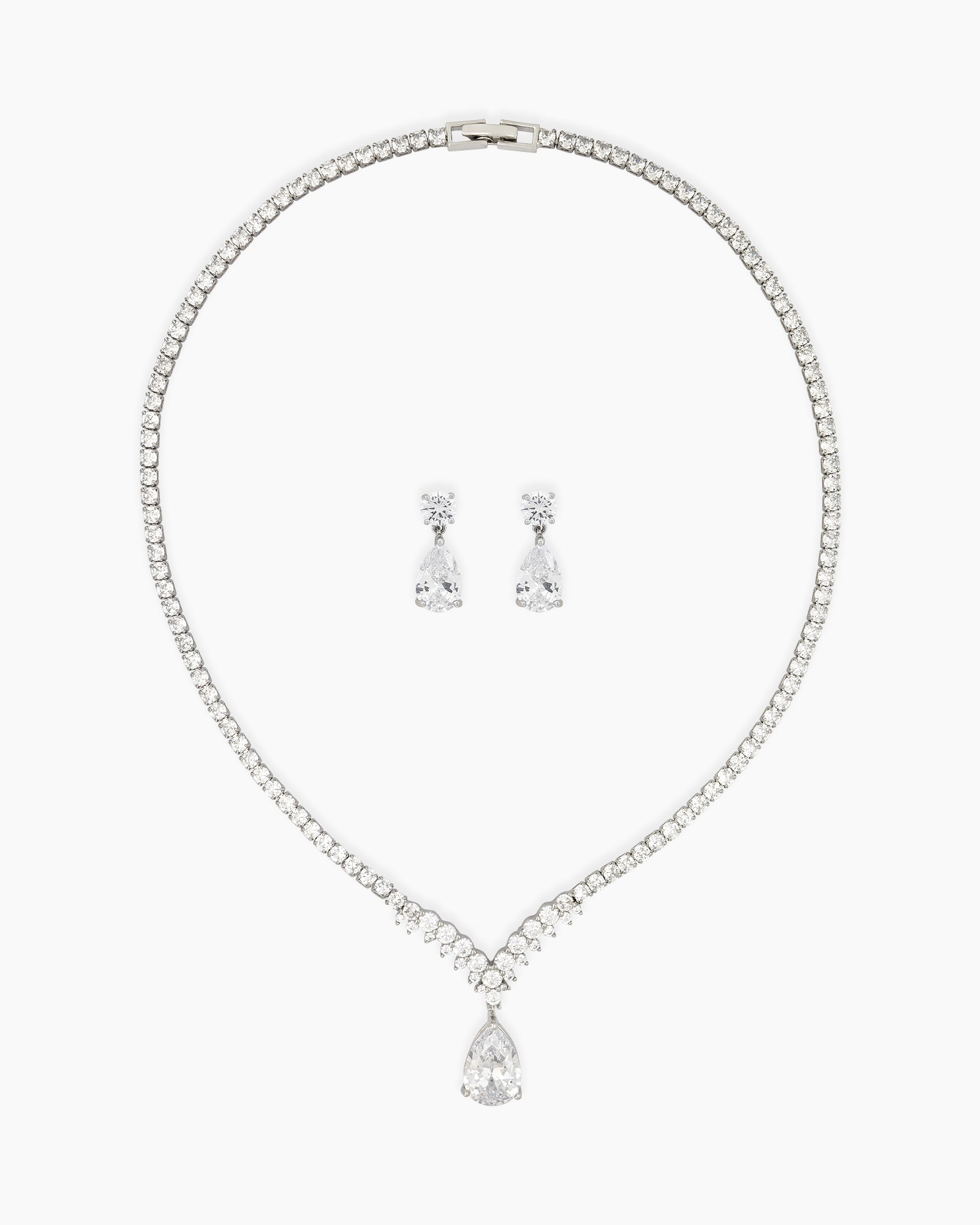 A jewelry set with a graceful V-shaped line of white zircons and a shimmering teardrop centerpiece