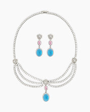 A set with a cascading esclavage-style necklace and matching earrings in soft pink and ocean-blue drops