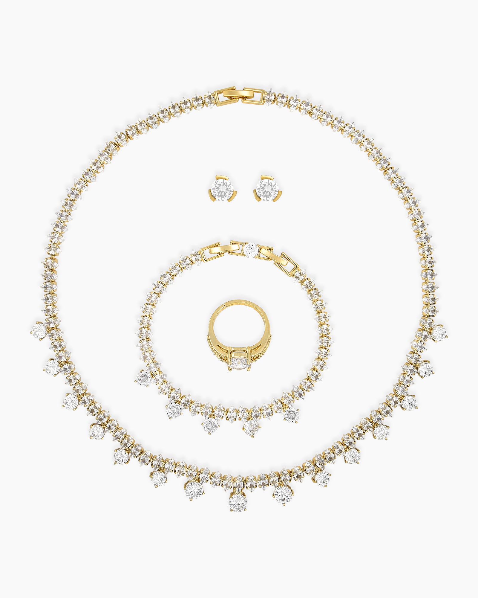 A jewelry set with a collar necklace, bracelet, earrings, and ring, all in gleaming gold tones