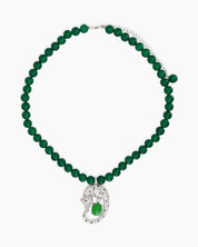 A necklace with a full strand of deep green jade beads and a striking silver-tone panther pendant