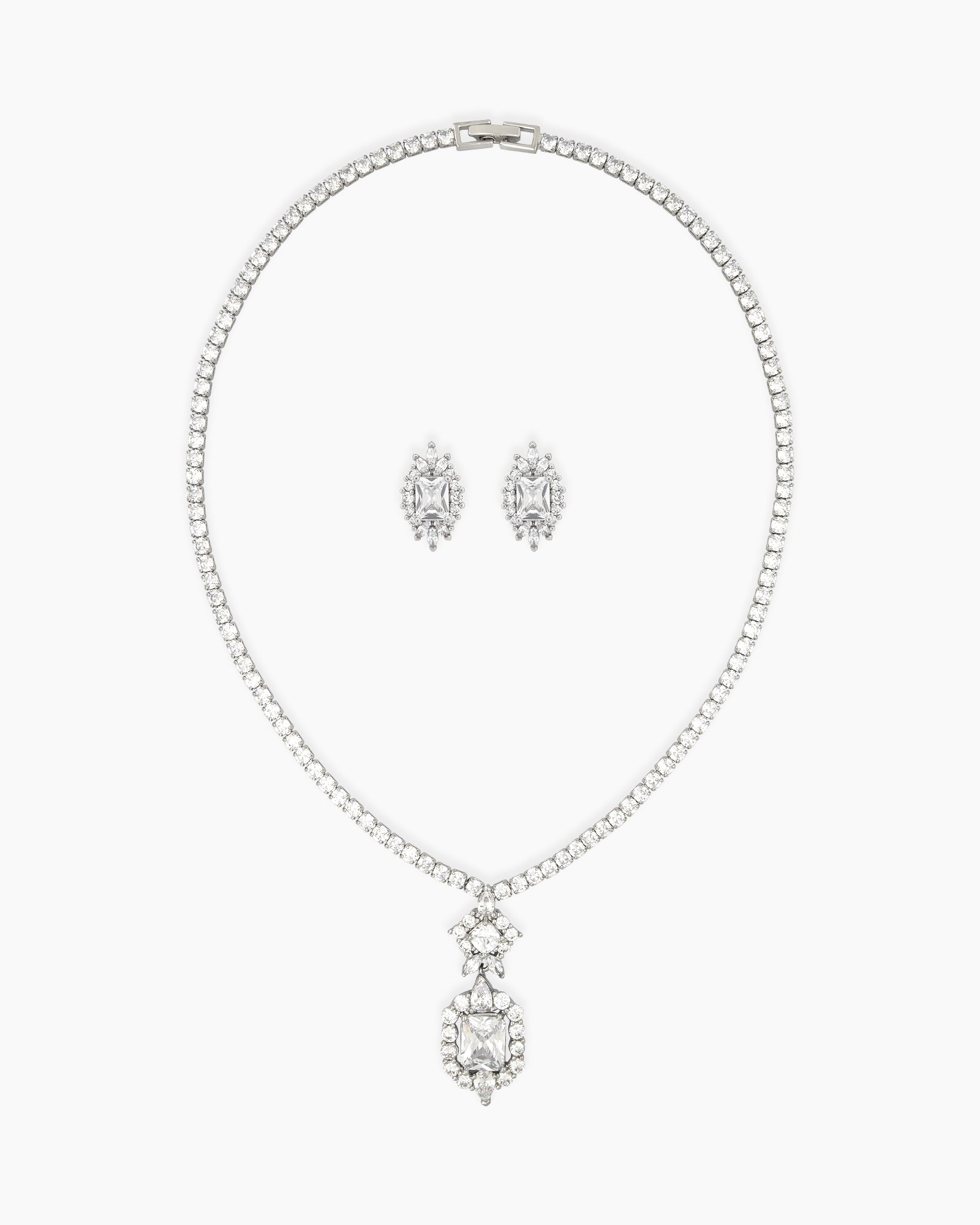 A jewelry set with a brilliant emerald-cut pendant and matching marquise-inspired earrings