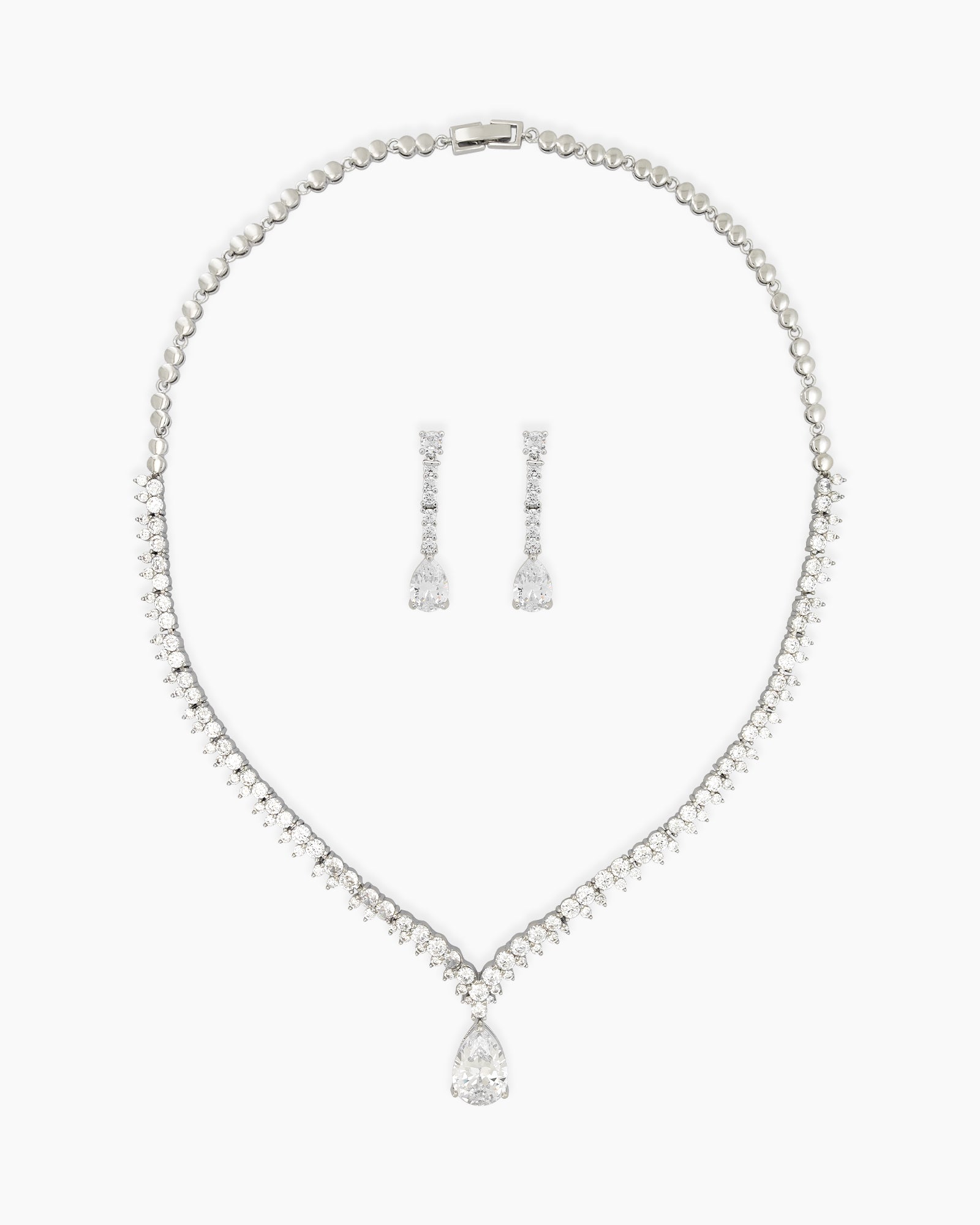 A jewelry set with a tapered v-shaped necklace and matching pear-cut drop earrings for pure sophistication