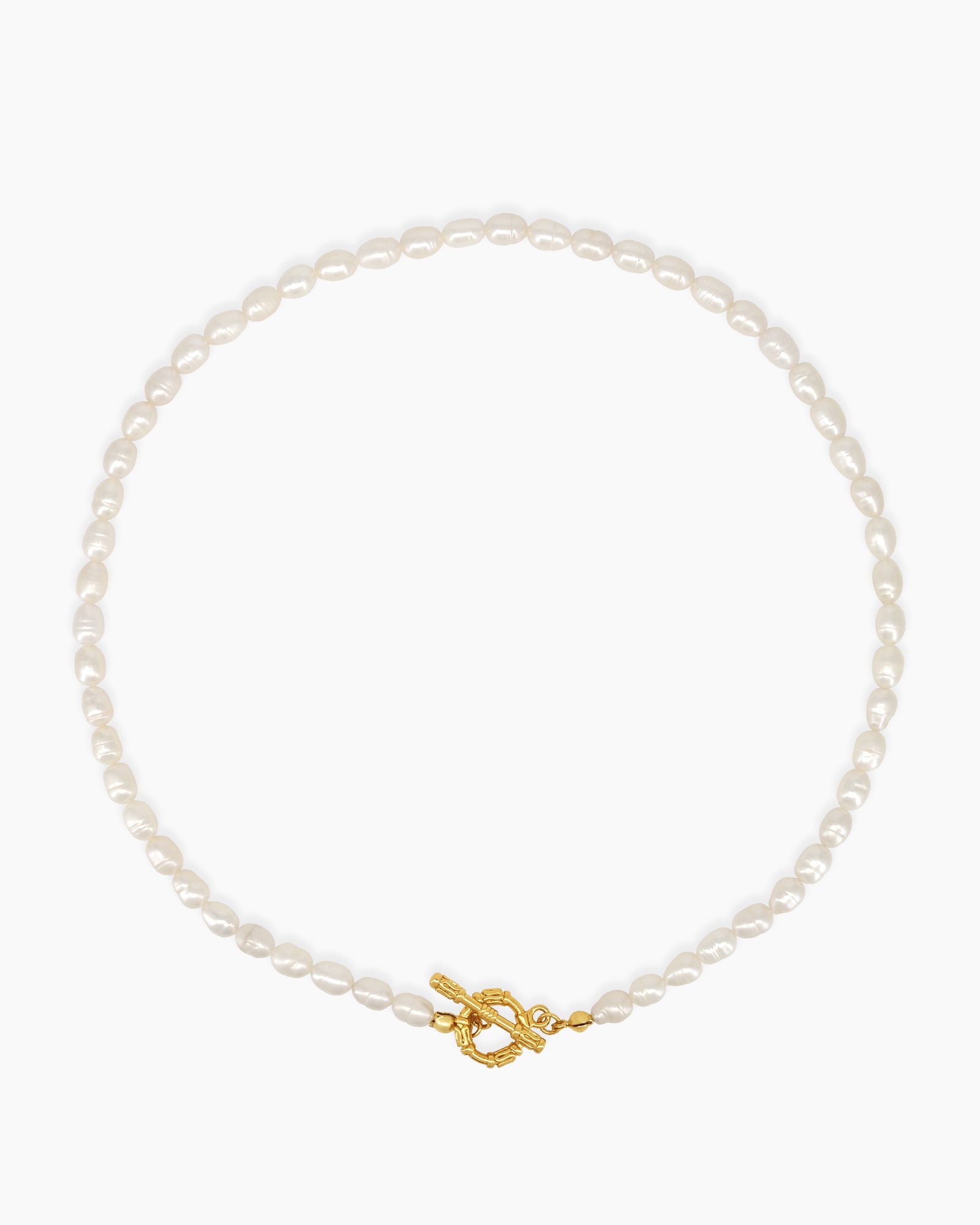 A necklace of lustrous freshwater pearls strung in a graceful silhouette with a gleaming gold toggle clasp
