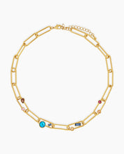 A necklace of oversized gold-tone paperclip links, adorned with an array of multicolored crystal stones