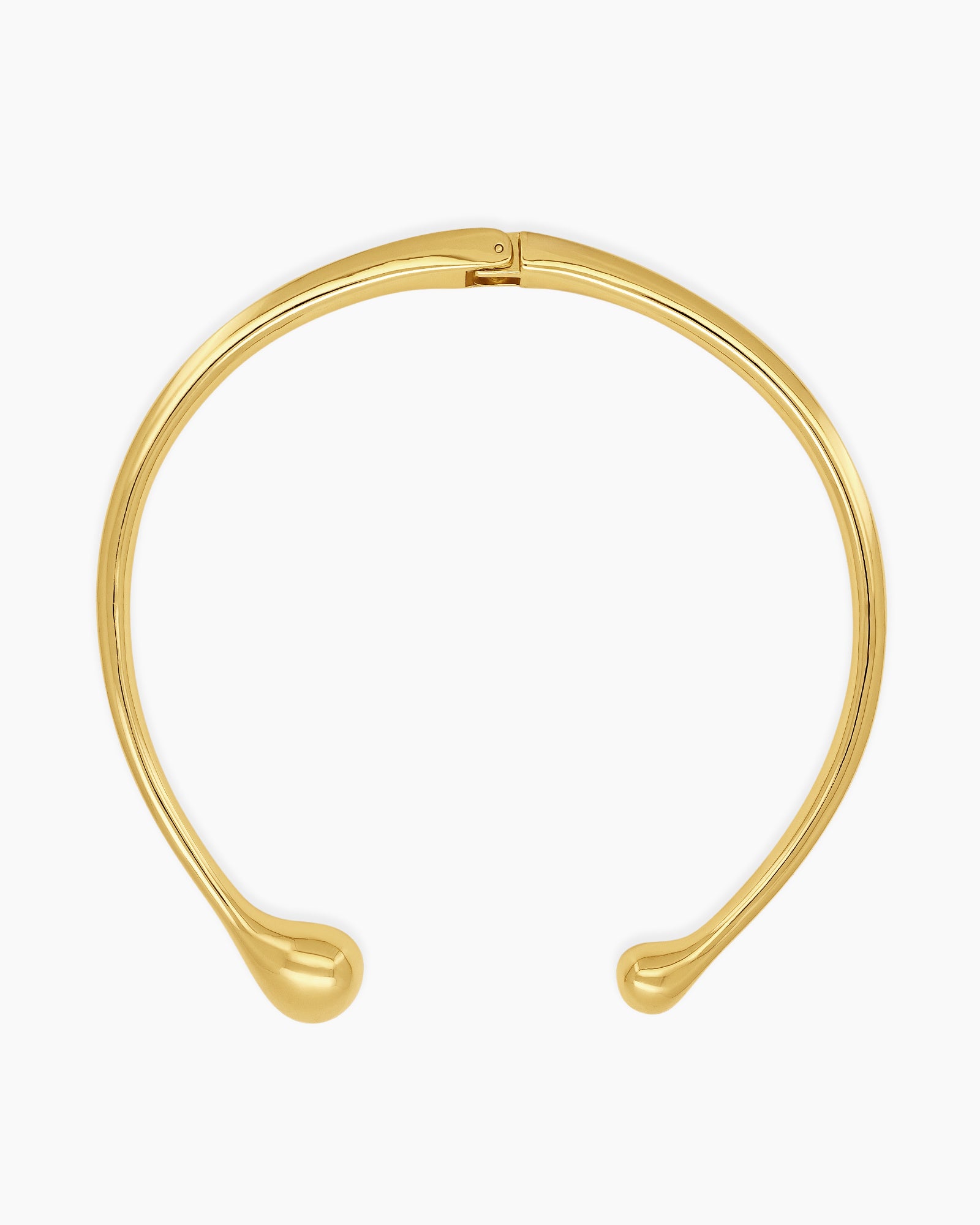 A polished gold necklace featuring a clean, wide torque design with smooth, droplet-like tips