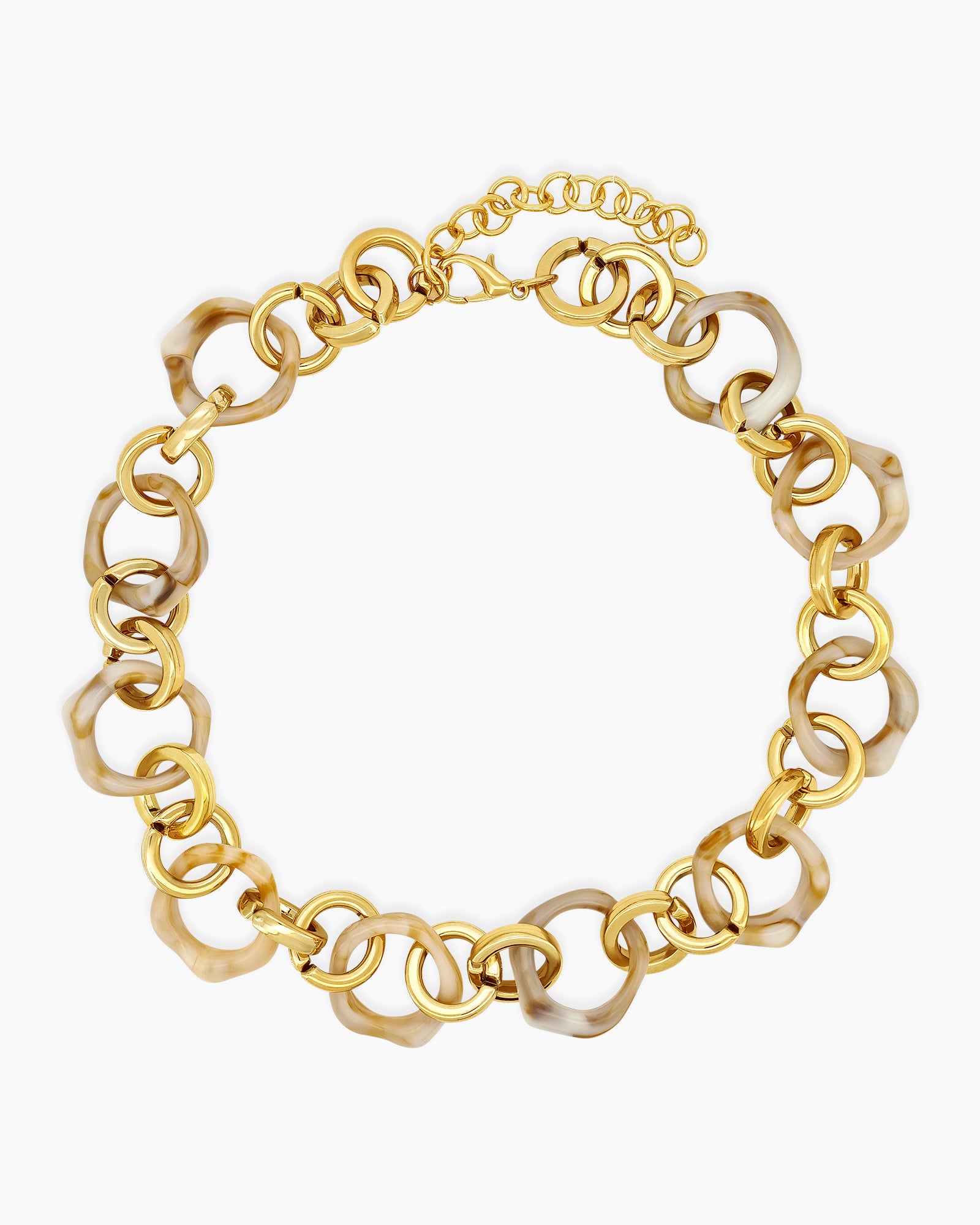 A necklace of oversized marbled ivory links intertwined with glossy gold-tone chains