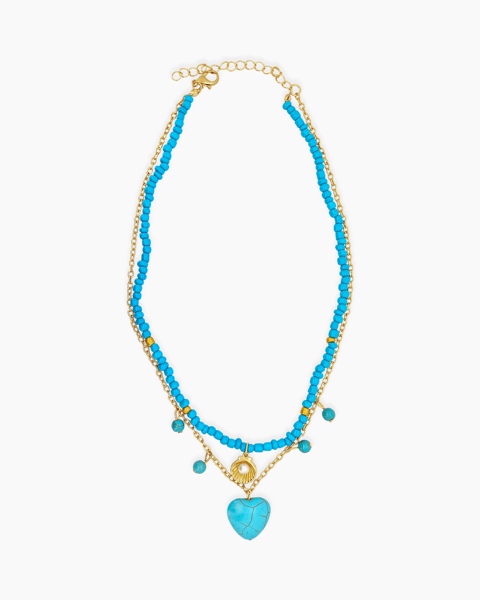 A multi-strand necklace of turquoise beads, delicate gold chains, a shell charm, and a heart stone