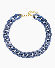 A navy necklace of oversized curb links with a high-gloss metallic finish for an expressive look