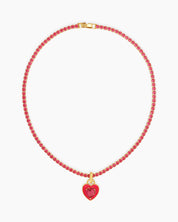 A rose-red tennis necklace with a full strand of zircon stones and an enamel heart charm with a center stone