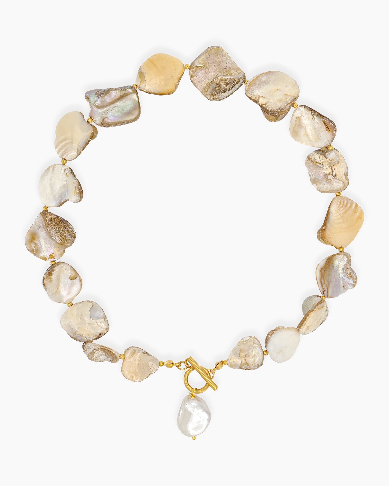 A choker of irregular shells in soft champagne hues with golden accents and a statement toggle clasp