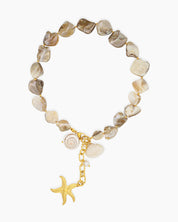 A necklace of irregular freshwater shell beads and luminous pearls with golden shell and starfish charms