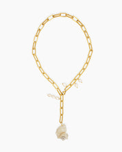 A chunky gold-tone paperclip chain necklace with delicate pearl droplets and a statement conch shell pendant