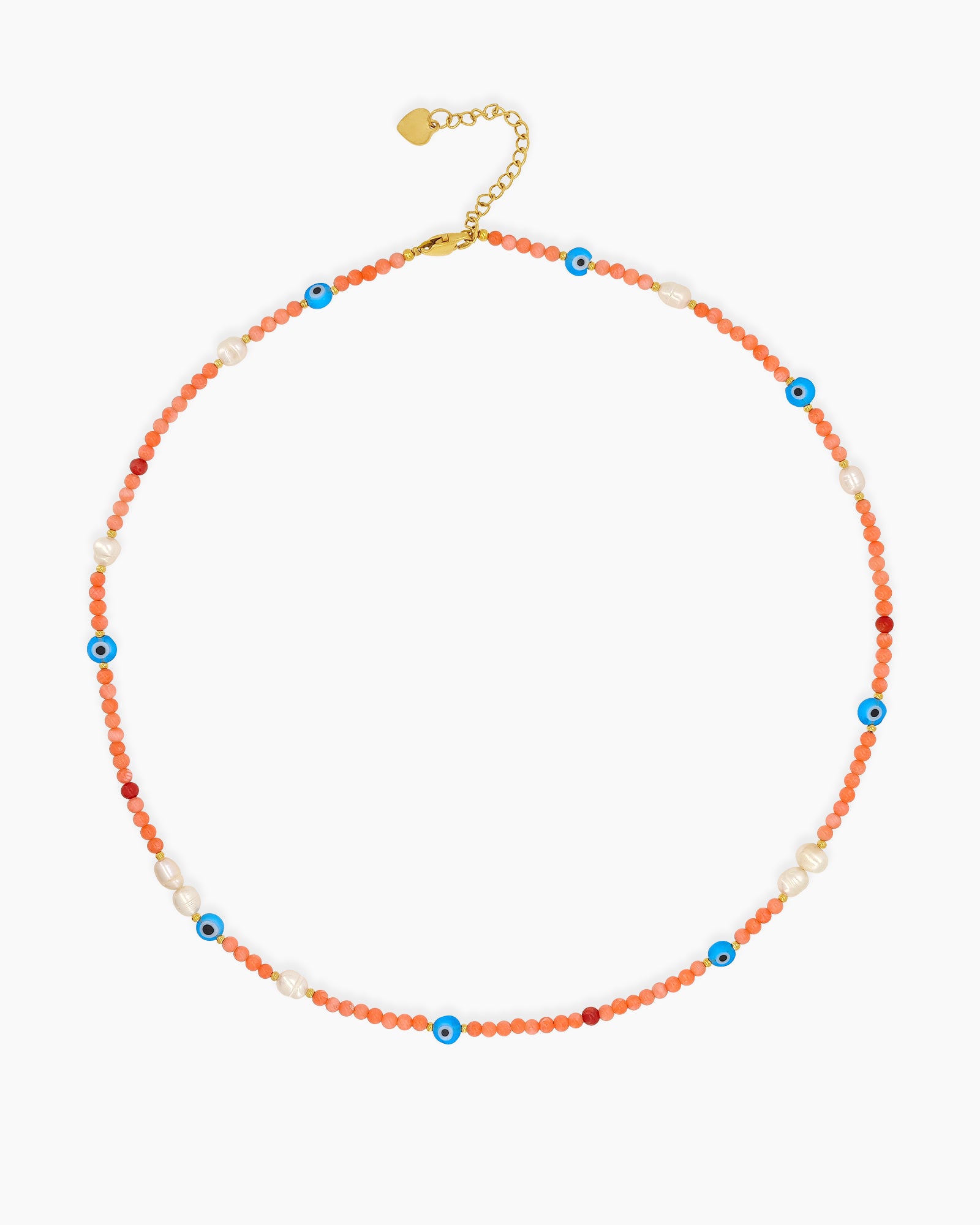 A necklace of coral-toned seed beads, freshwater pearls, and scattered evil eye charms in cobalt blue