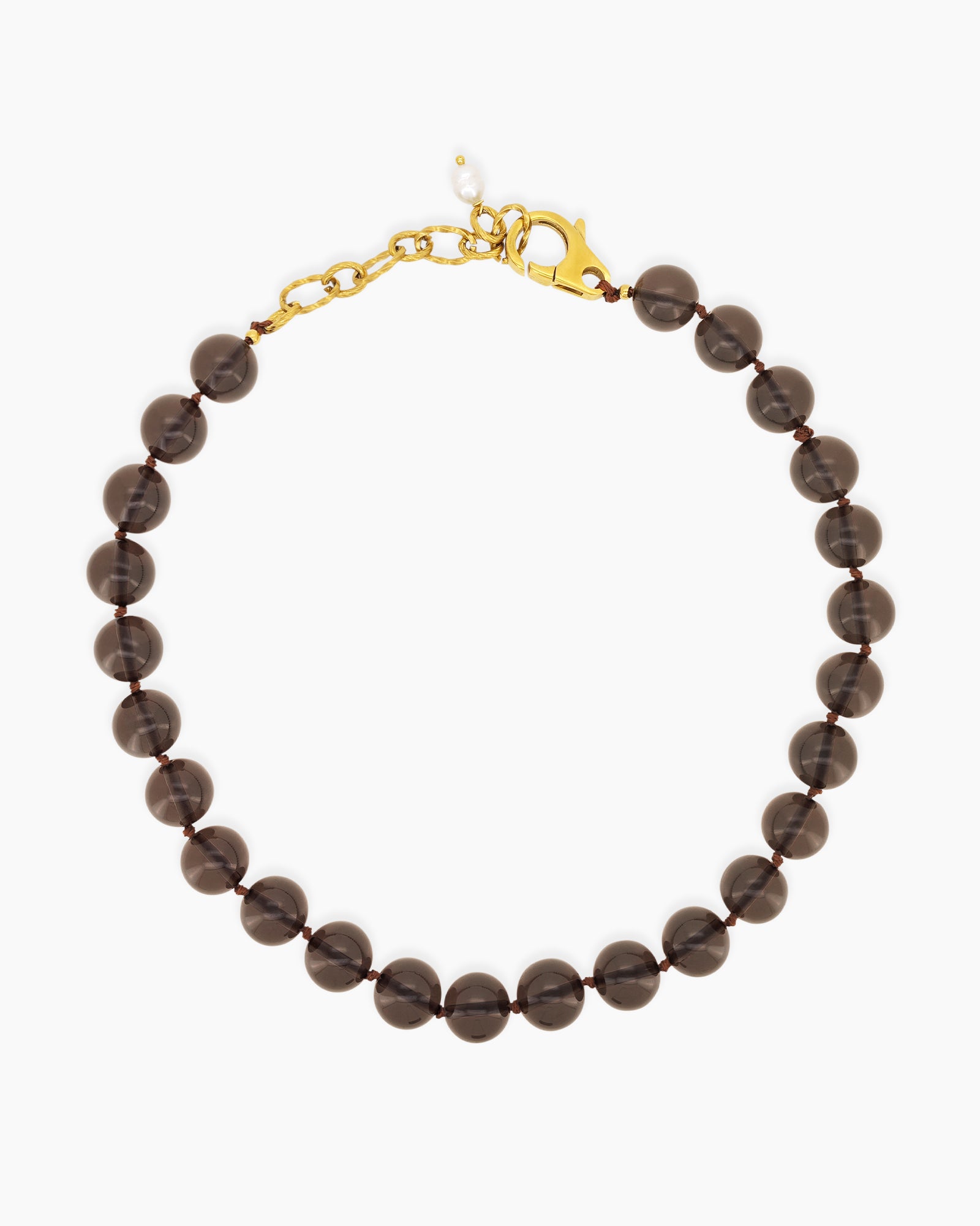 A '90s safari-style necklace with smooth, polished brown stones for a grounded, earthy charm