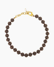 A '90s safari-style necklace with smooth, polished brown stones for a grounded, earthy charm