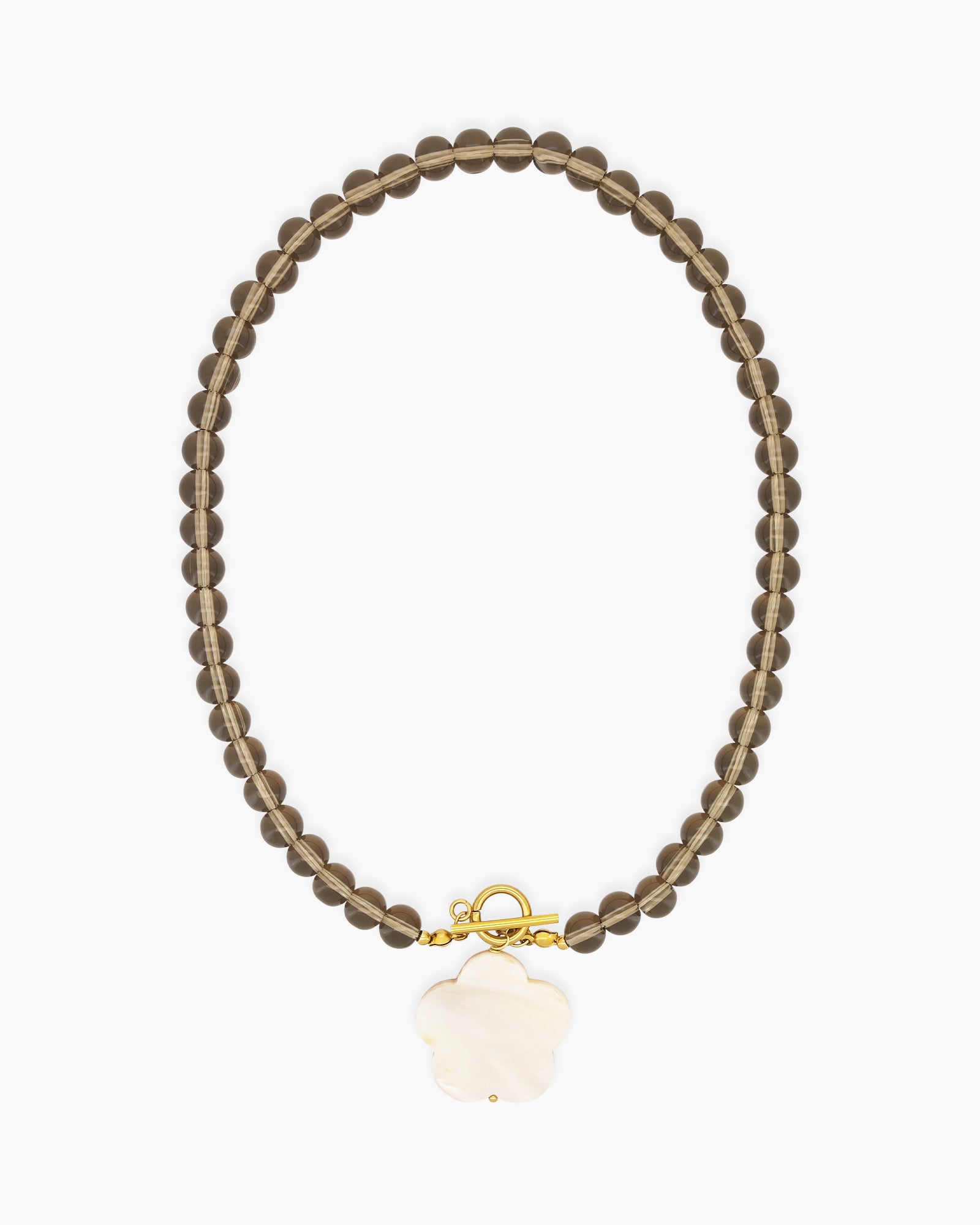 A necklace of glossy smoky glass beads with a luminous mother-of-pearl flower pendant and a toggle clasp