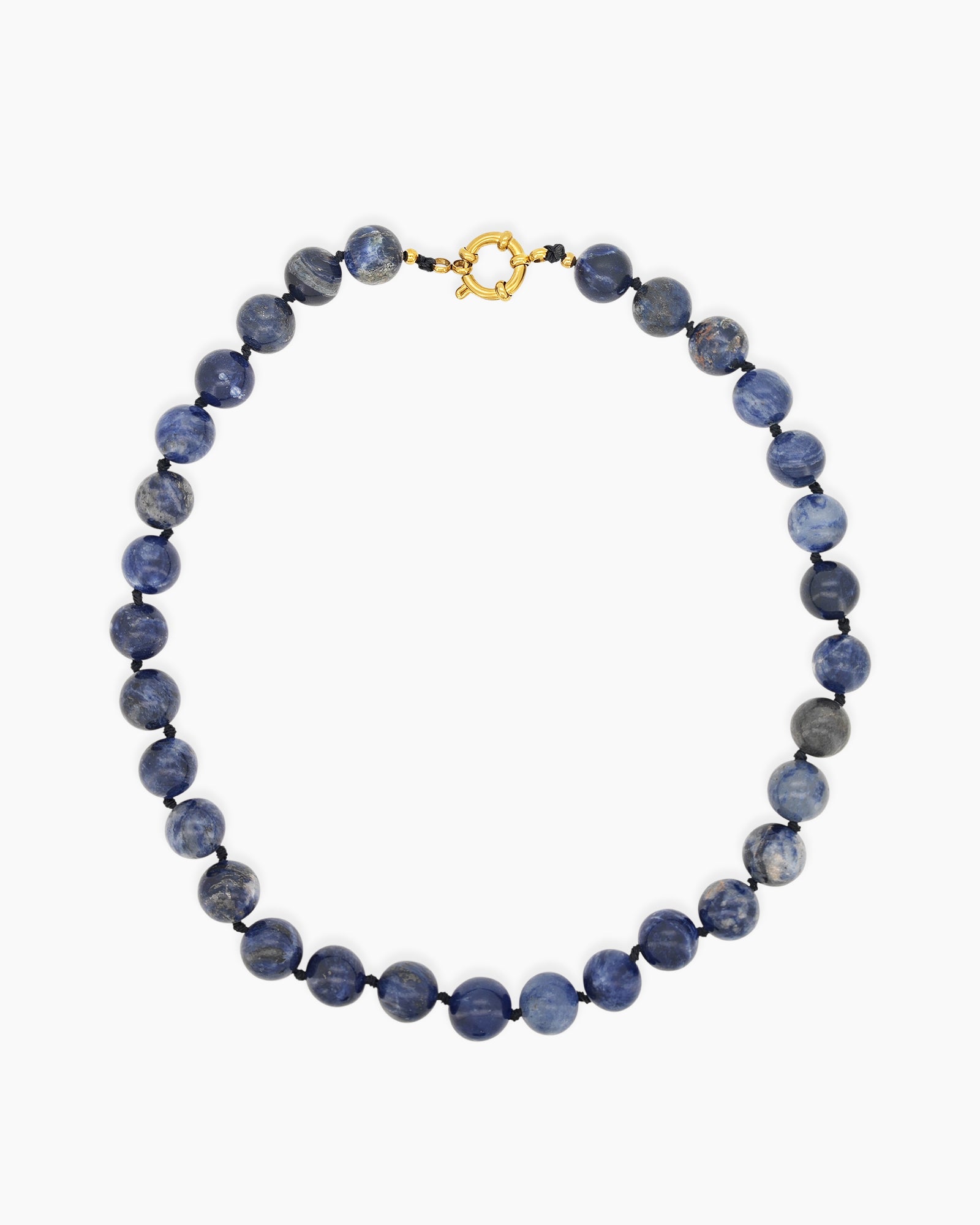 A hand-knotted necklace of deep blue lapis lazuli stones, each speckled like a miniature galaxy