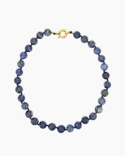 A hand-knotted necklace of deep blue lapis lazuli stones, each speckled like a miniature galaxy