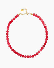 A timeless necklace with a strand of polished coral beads in rich raspberry-red tones for a bold look