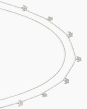 A silver waist chain with two layered strands adorned with dainty butterfly charms for a carefree spirit