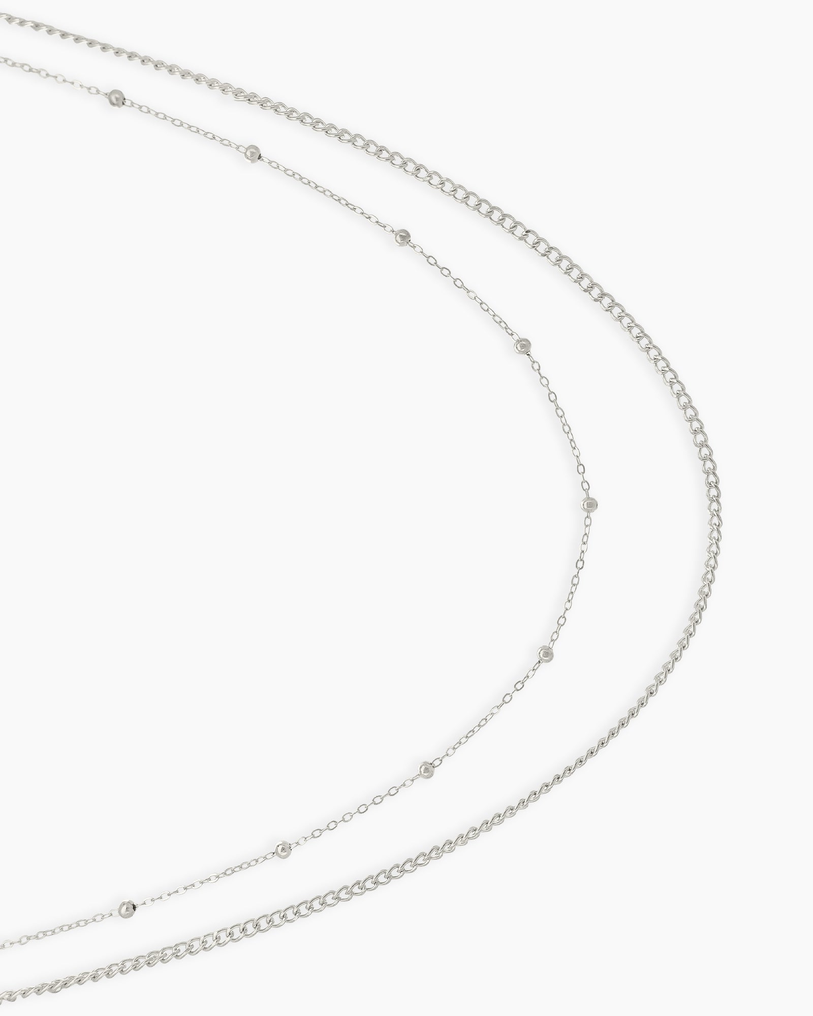 A double-layered silver waist chain with one sleek and one delicately dotted strand for a minimal, chic look