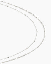 A double-layered silver waist chain with one sleek and one delicately dotted strand for a minimal, chic look