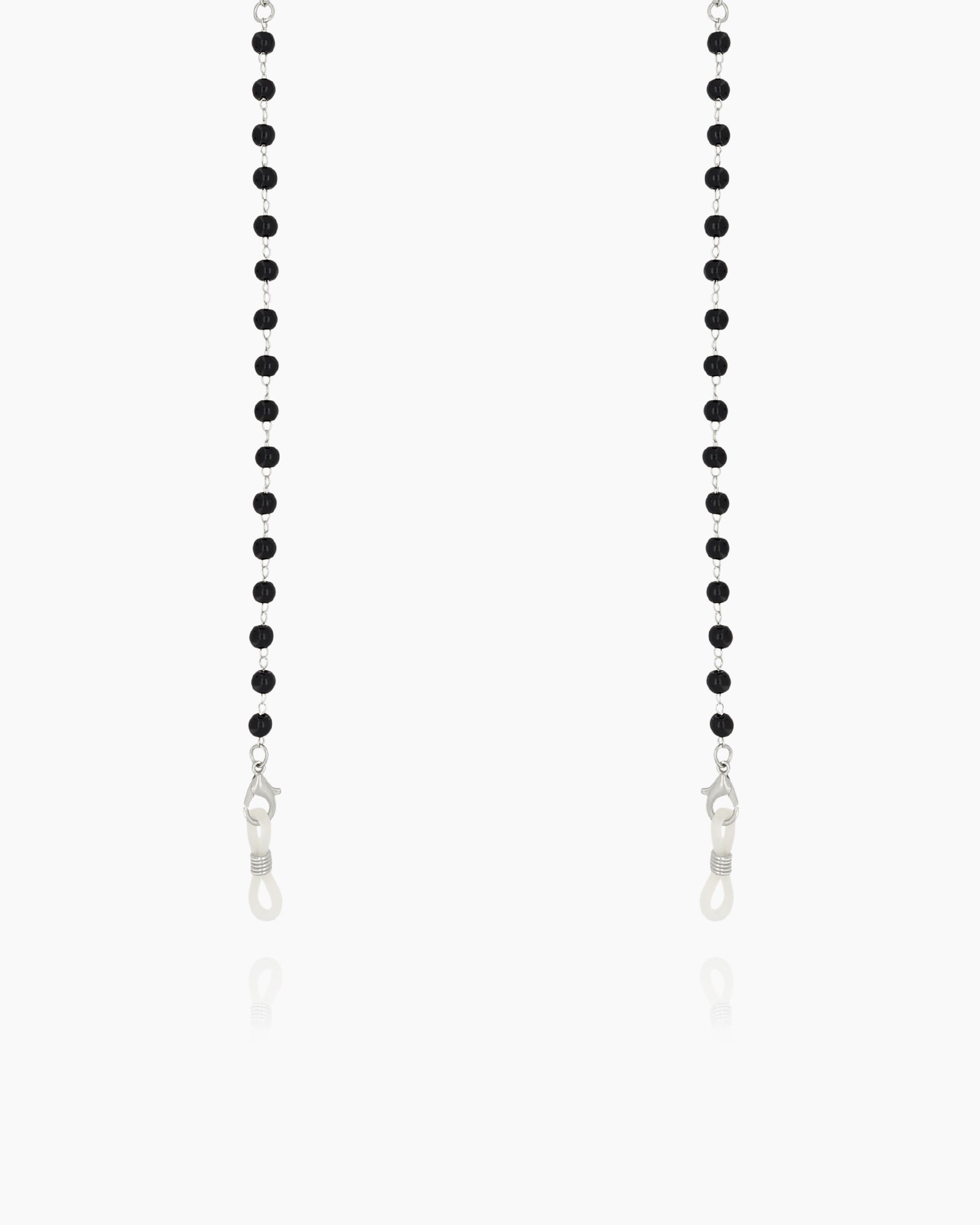 A minimalist glasses chain with tiny faceted black beads along a fine silver-tone chain