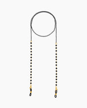 A glasses chain with sleek black faceted beads paired with fine double-link chains for a subtle edge