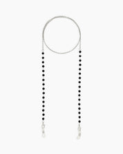 A minimalist glasses chain with tiny faceted black beads along a fine silver-tone chain