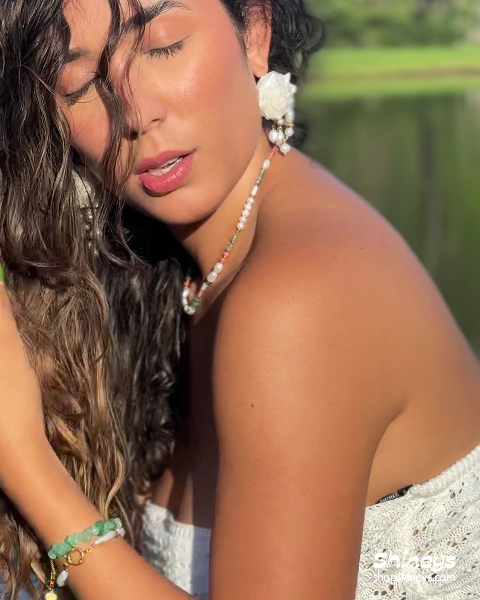 A sea-inspired jewelry collection of luminous pearls, sculptural shells, and a delicate gold waist chain