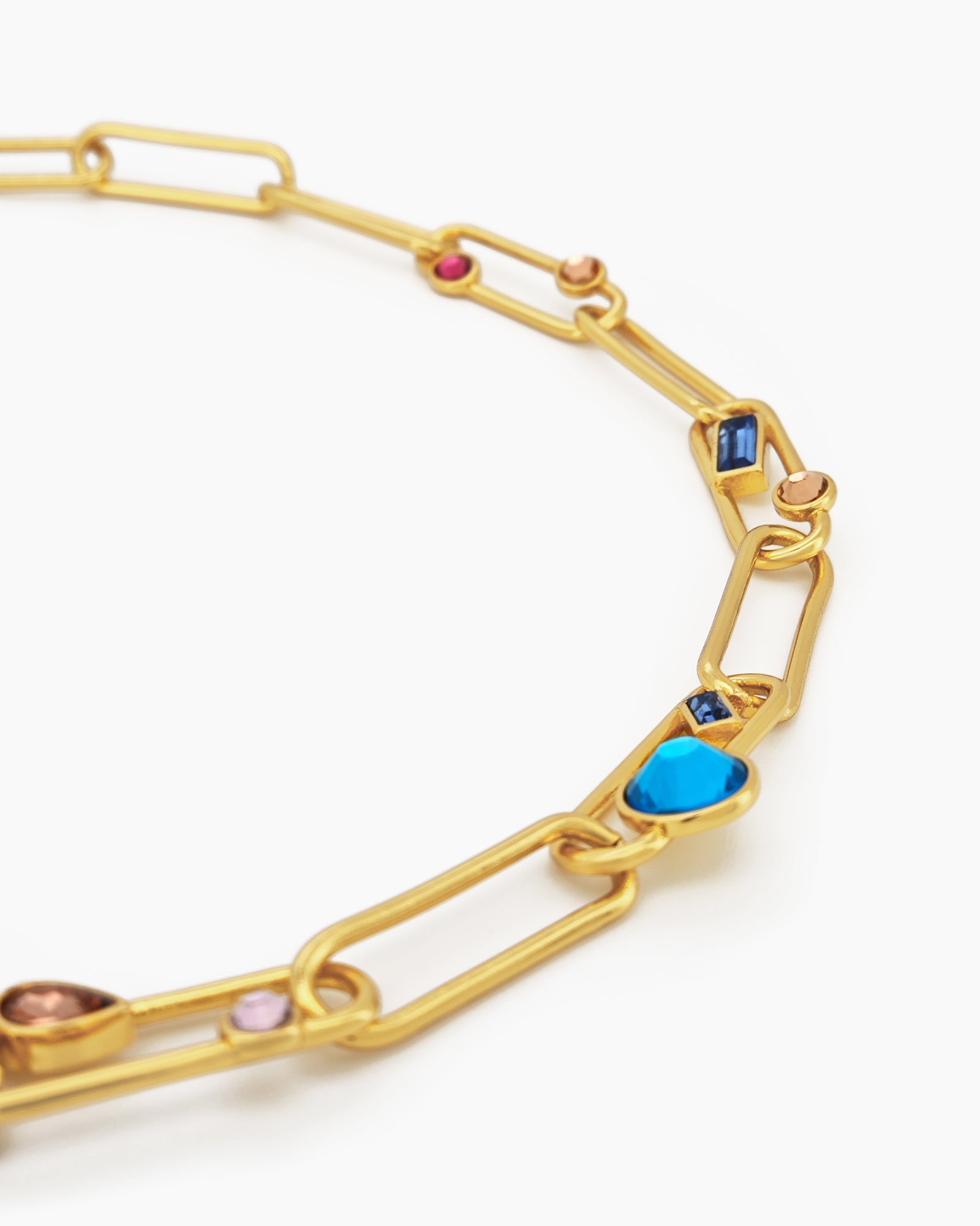 A necklace of oversized gold-tone paperclip links, adorned with an array of multicolored crystal stones