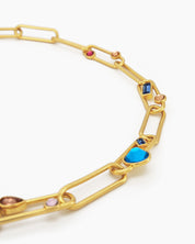 A necklace of oversized gold-tone paperclip links, adorned with an array of multicolored crystal stones