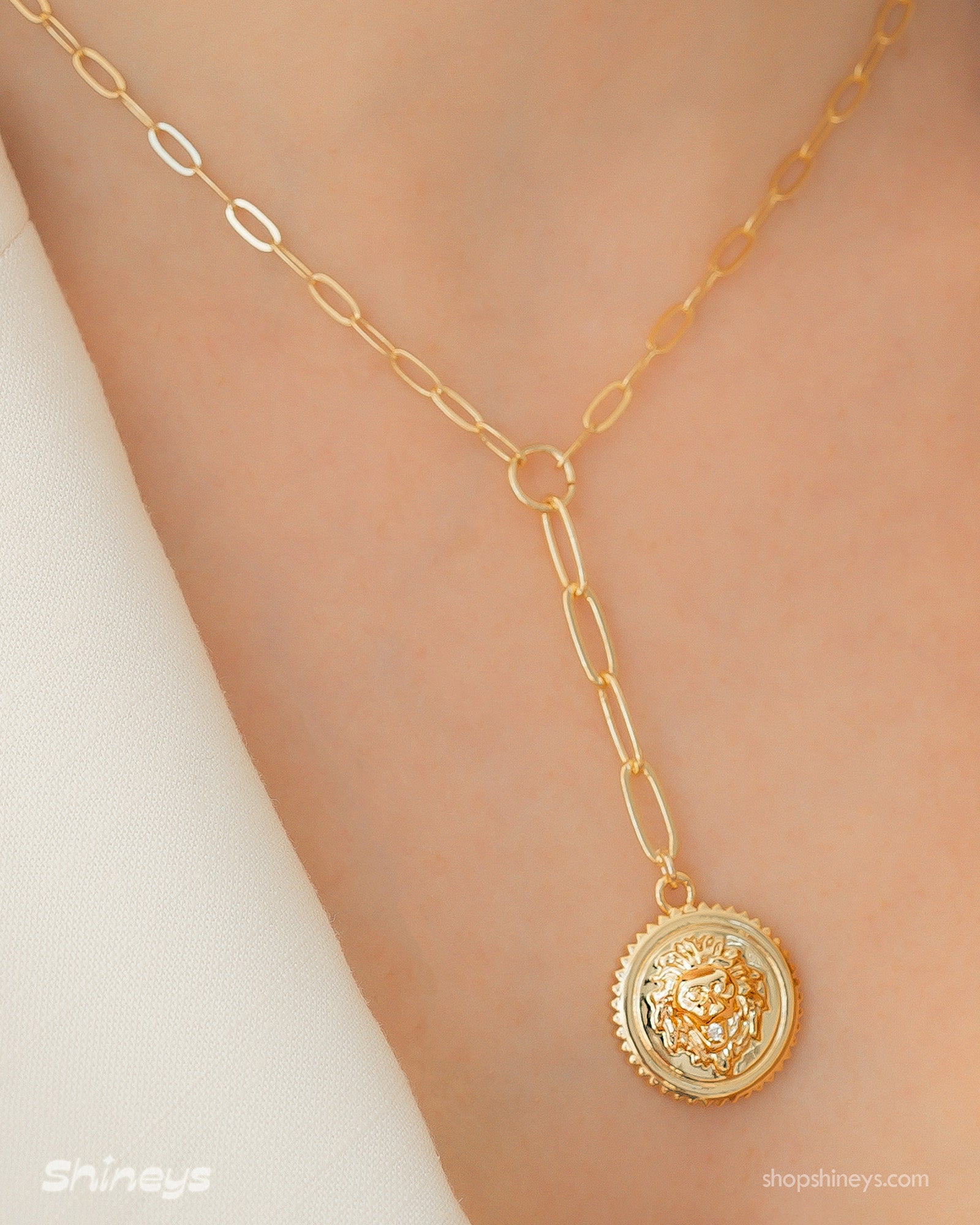 A Y-shaped necklace with a bold lion medallion and elongated paperclip chain links for a regal aesthetic