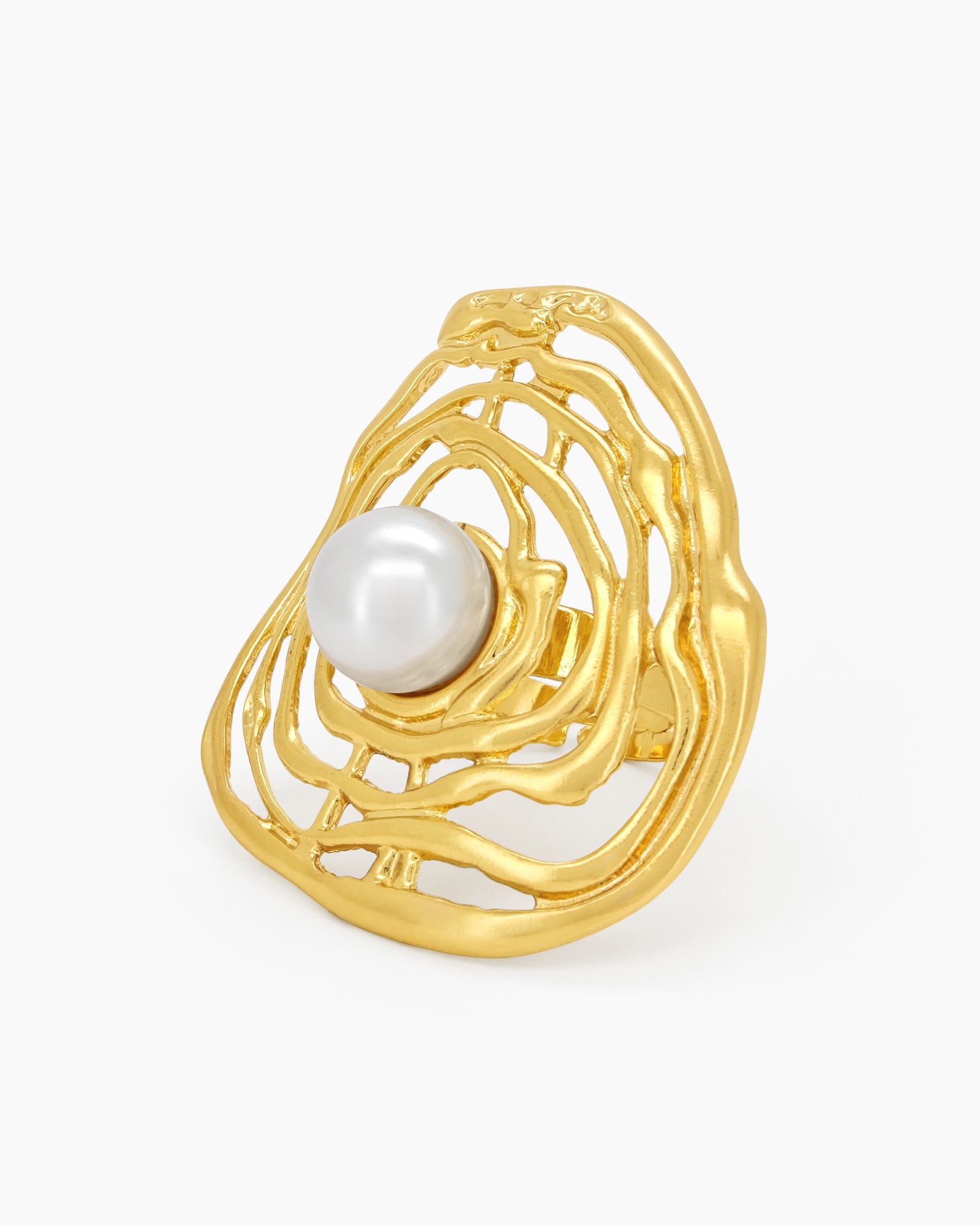 A sculptural gold ring with an abstract shell design cradling a luminous faux pearl